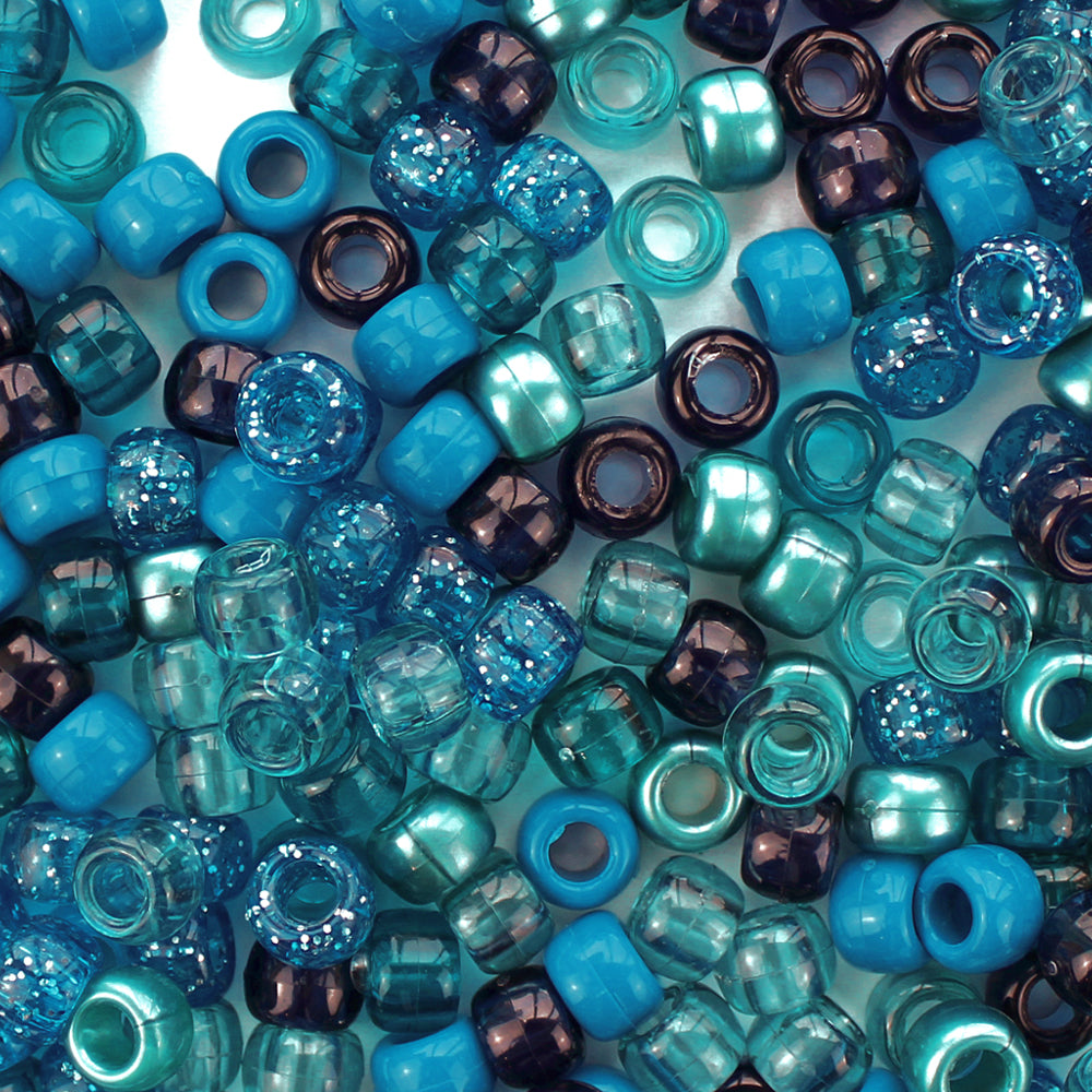 mixed colors of pony beads in a deep blue and turquoise ocean inspired color scheme