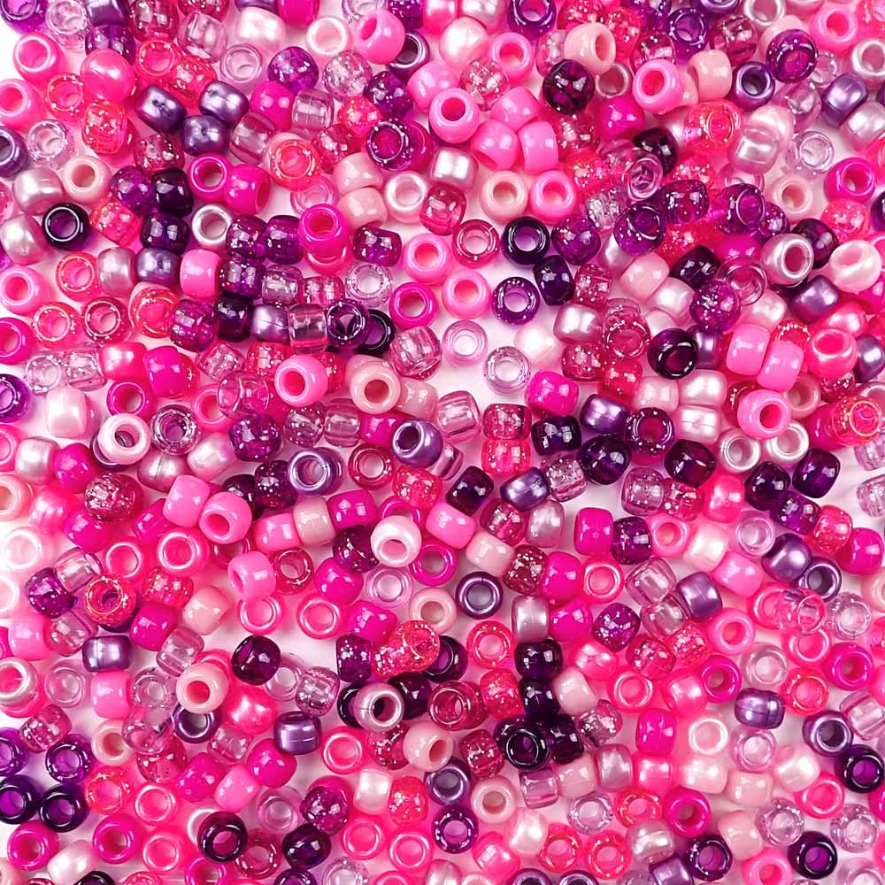 a mix of pony beads in various shades of pink and purple